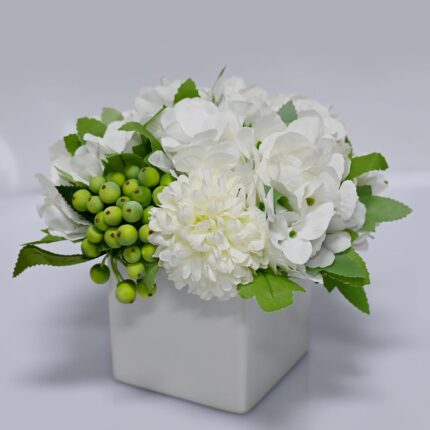 Faux hydrangea arrangement in a ceramic vase